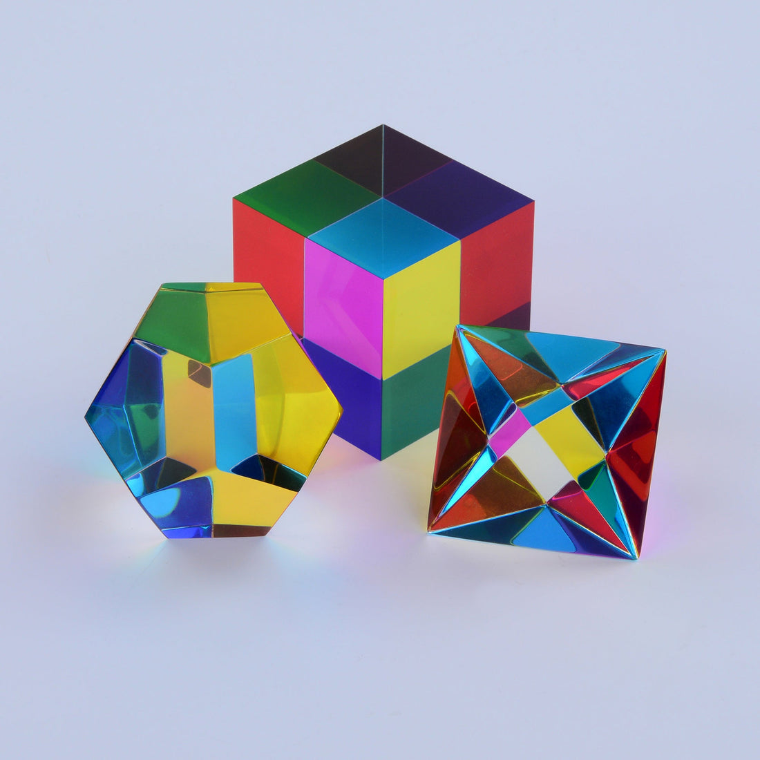 Three translucent CMY solids overlapping, producing a magenta that appears in no rainbow