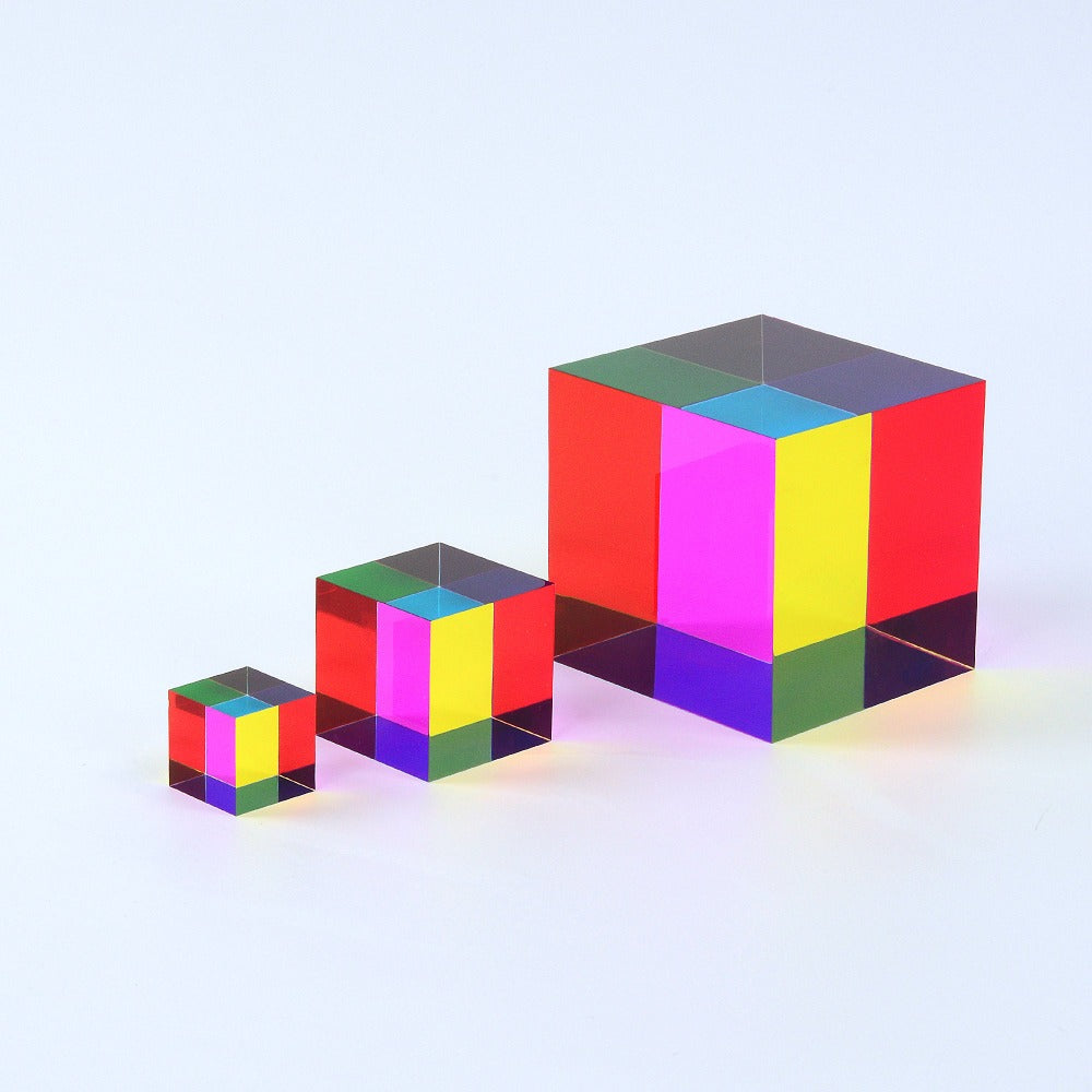 A translucent CMY Cube held to the light, its faces overlapping into colours the eye rarely sees